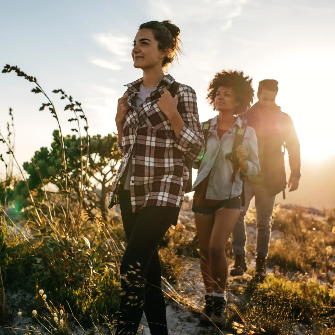 Group of friends hiking at sunset