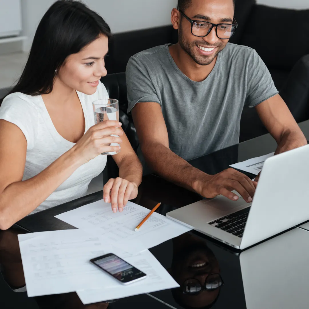 Couple planning finances together with laptop