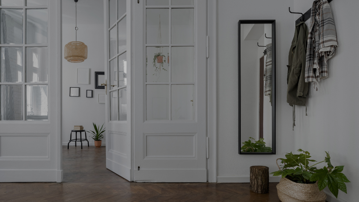 A tidy home interior with white doors and a hanging coat, illustrating the experience of hiring cleaning help that did not meet expectations, stressing the importance of clear goals and effective time management.
